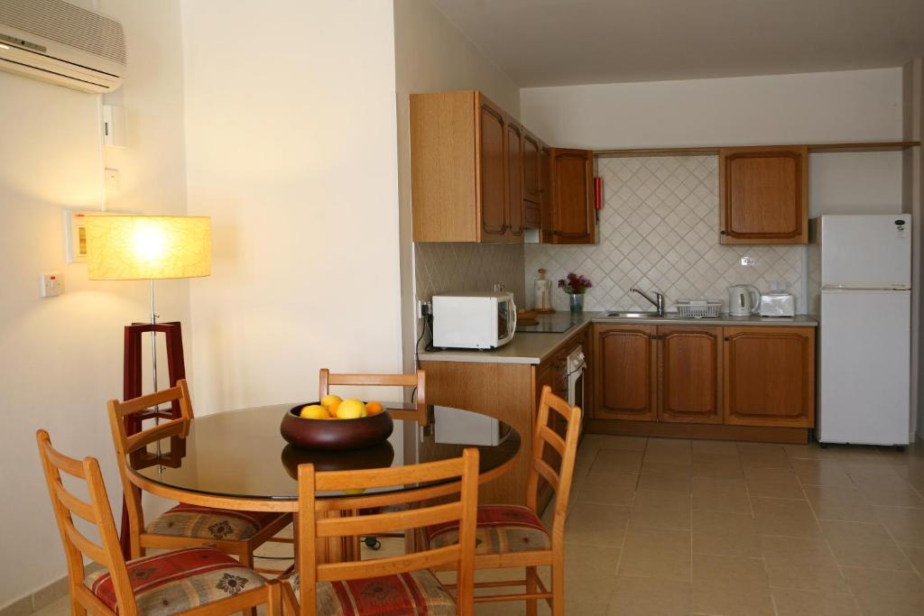a kitchen with a table with a bowl of fruit on it at Club Aphrodite in Erimi