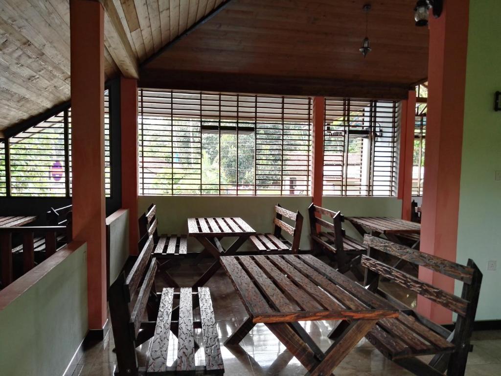 カトゥナーヤカにあるLeopard Rock Family Restの木製のベンチ2台と窓が備わる空き部屋
