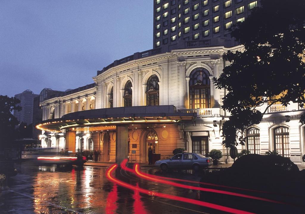 a building with a car parked in front of it at Okura Garden Hotel Shanghai in Shanghai