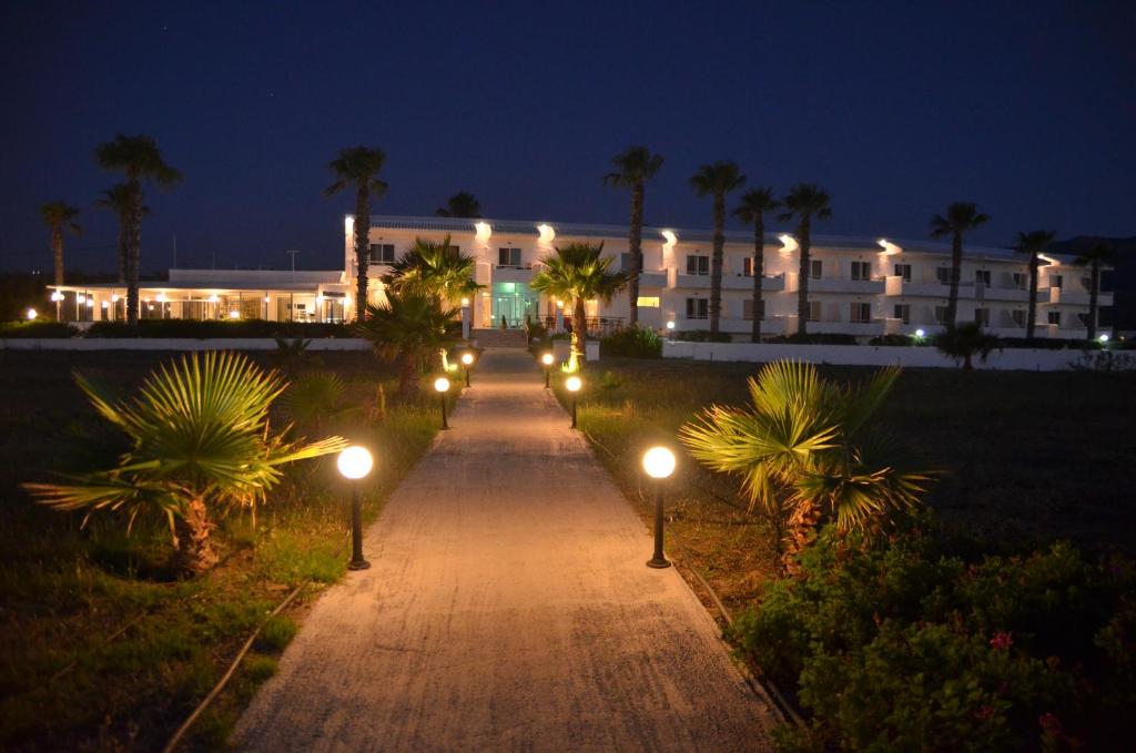 a pathway leading to a large building at night at Costa Angela Seaside Resort in Kos Town