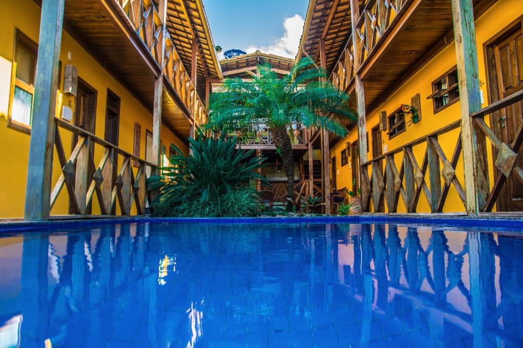 a swimming pool in the middle of a building at Pousada Pérola Do Morro in Morro de São Paulo