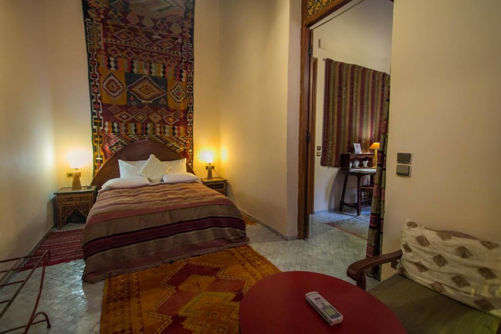a bedroom with a bed and a couch in a room at Riad Dar Cordoba in Fès