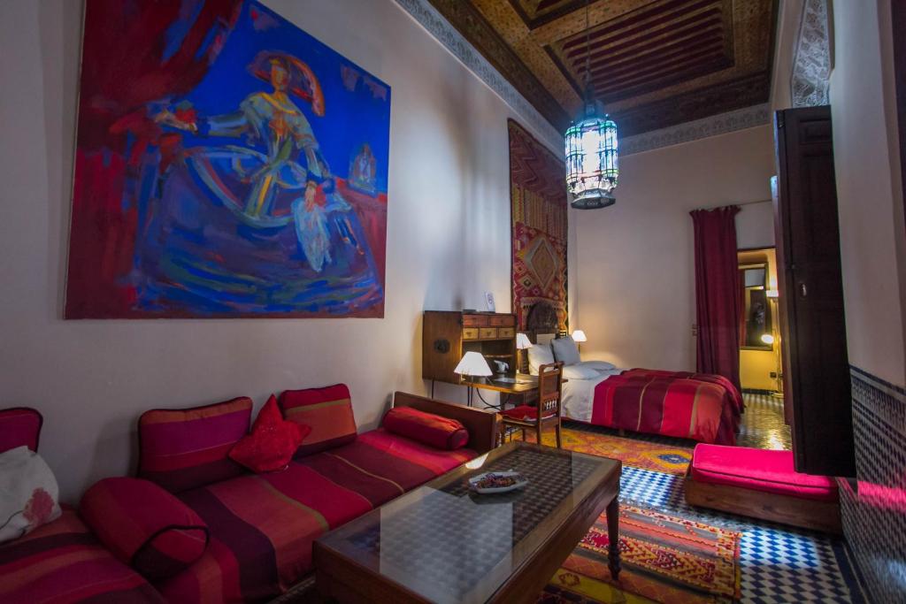 a living room with a couch and a table at Riad Dar Cordoba in Fès