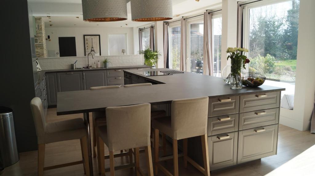 a kitchen with a large island with a counter top at Les terrasses de Templeuve in Templeuve