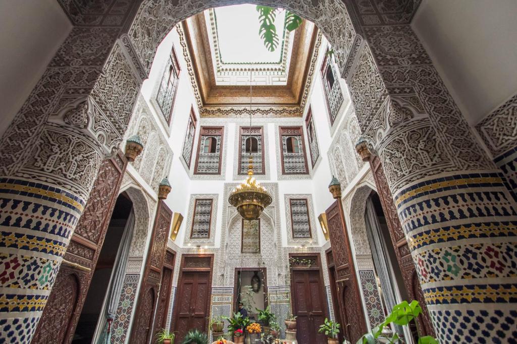 a hallway of a building with a large archway at Riad Dar Cordoba in Fès
