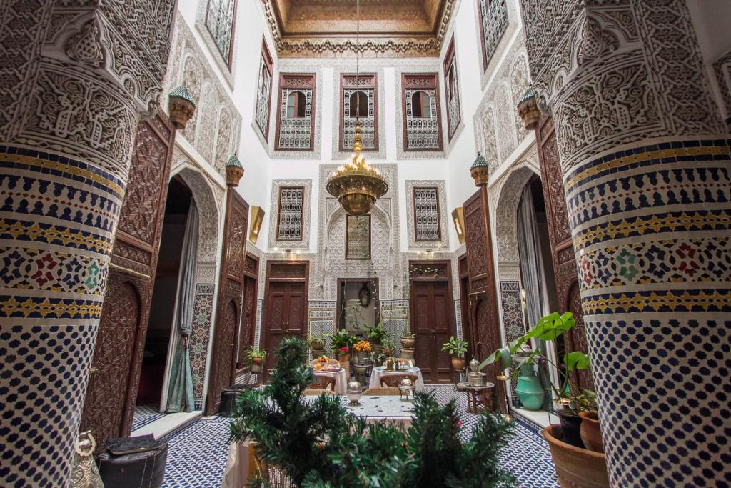 an ornate room with a table in a building at Riad Dar Cordoba in Fès
