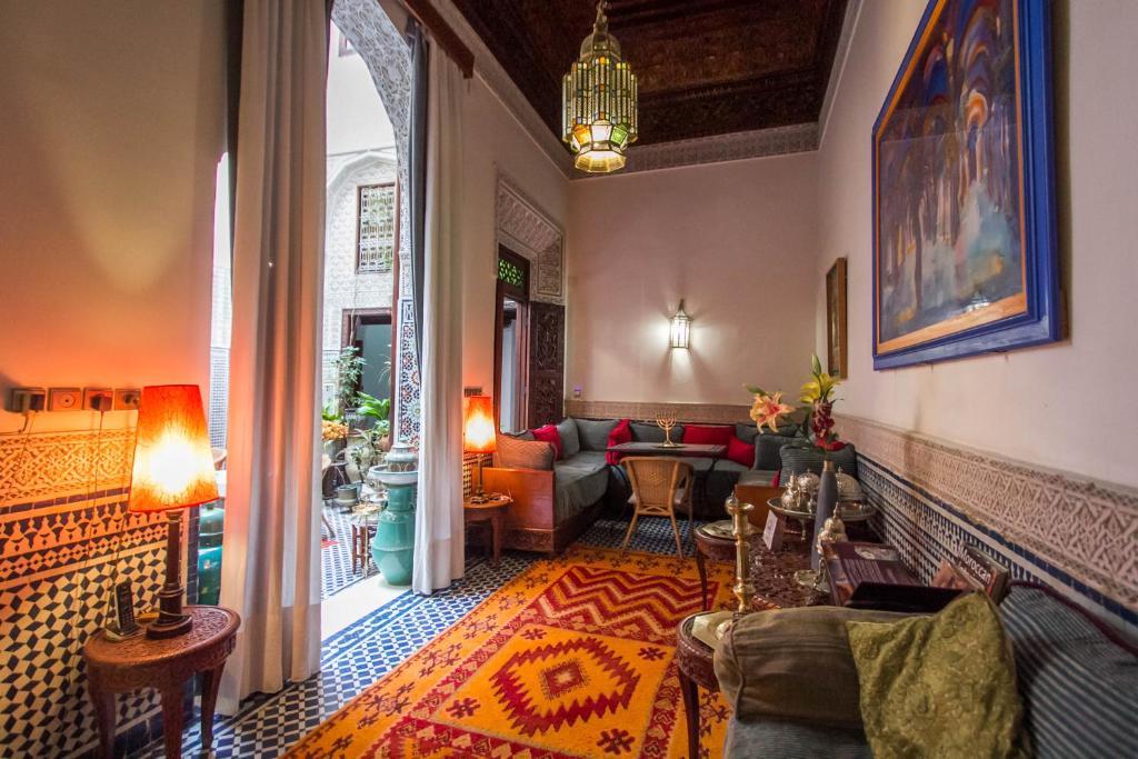 a living room with a couch and a table at Riad Dar Cordoba in Fès