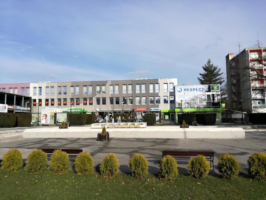 a large building with a parking lot in front of it at Penzion Luxury in Rožňava