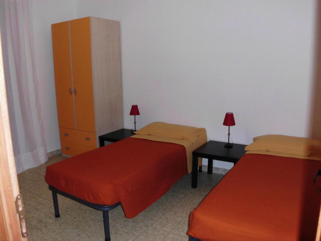 Ένα ή περισσότερα κρεβάτια σε δωμάτιο στο Villaggio Santa Rita