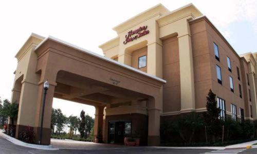 a large building with a clock on the front of it at Hampton Inn & Suites Orlando-John Young Parkway/South Park in Orlando