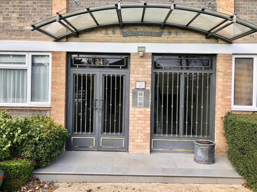 a front door of a brick building with a gate at Central apartment 5 mins Putney tube station in London