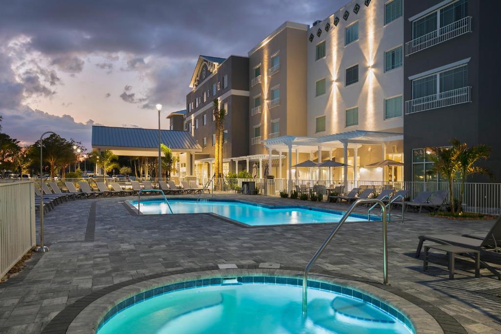 a swimming pool in front of a building at Carlisle Inn Sarasota in Sarasota