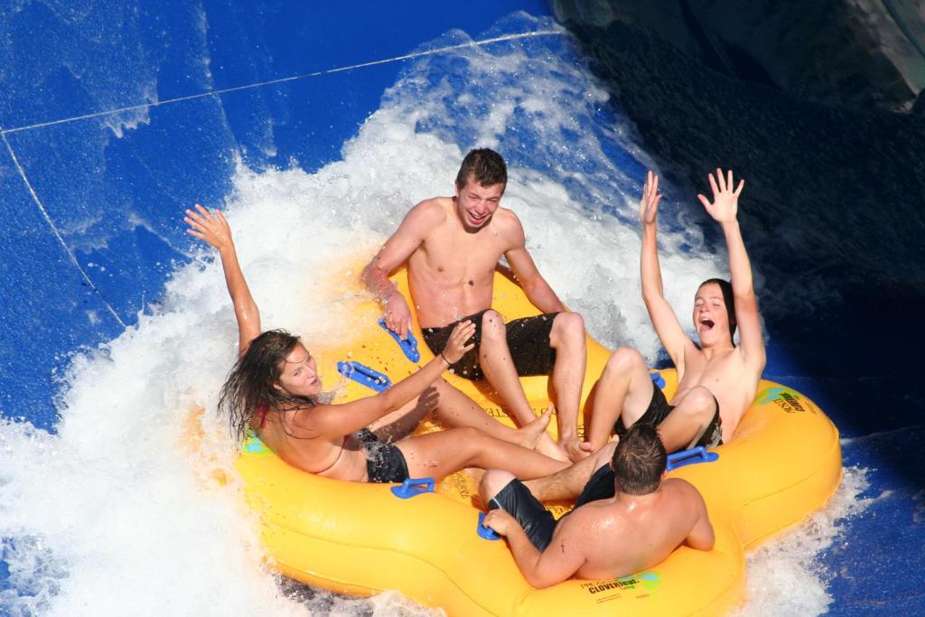 a group of men on a raft in the water at Imperia Hotel & Suites Saint-Eustache in Saint-Eustache