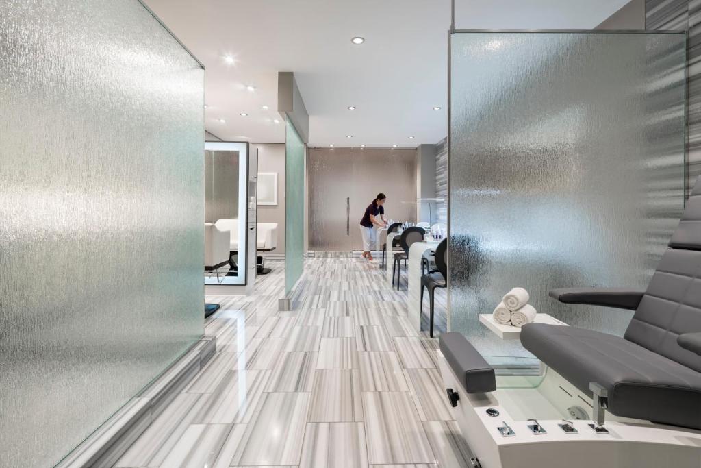 a woman is standing in a hair salon at Four Seasons Resort Orlando at Walt Disney World Resort in Orlando