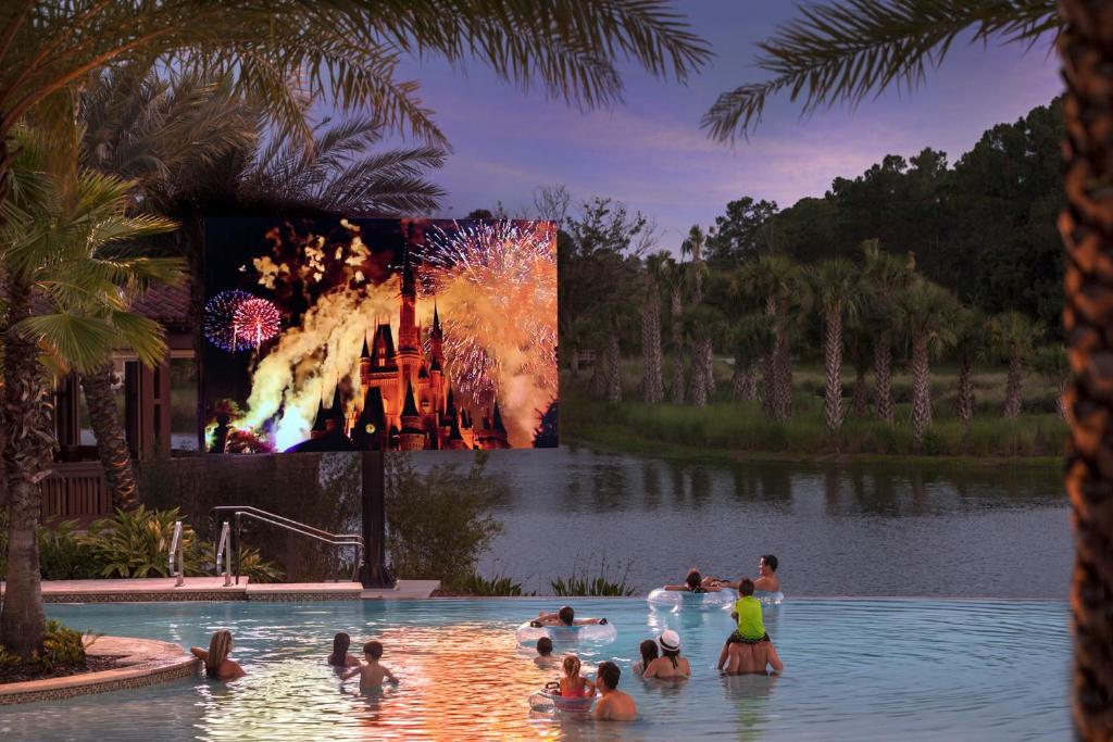 a group of people in a swimming pool with a movie at Four Seasons Resort Orlando at Walt Disney World Resort in Orlando