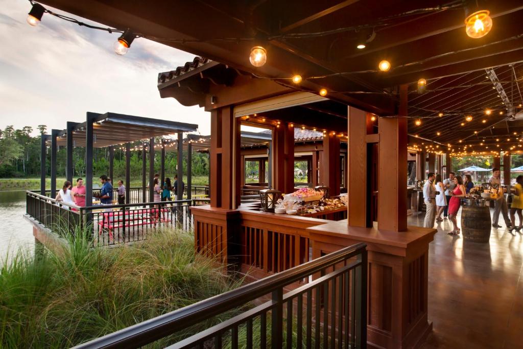 a food court with people walking around in a park at Four Seasons Resort Orlando at Walt Disney World Resort in Orlando