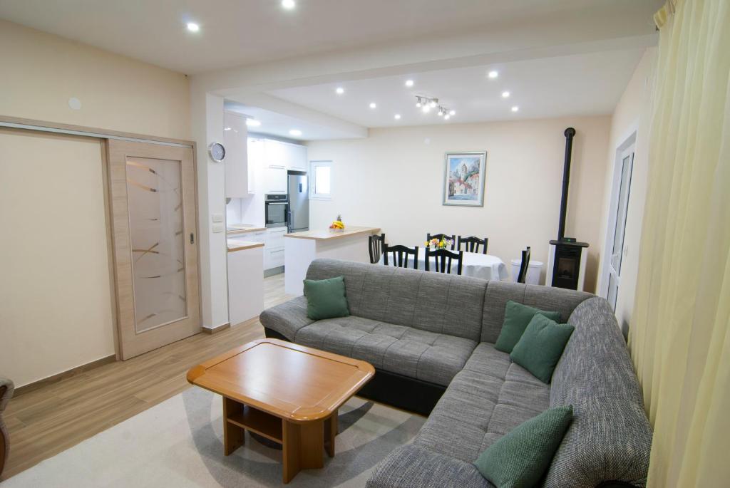 a living room with a couch and a table at Apartments Lokva in Lokva Rogoznica