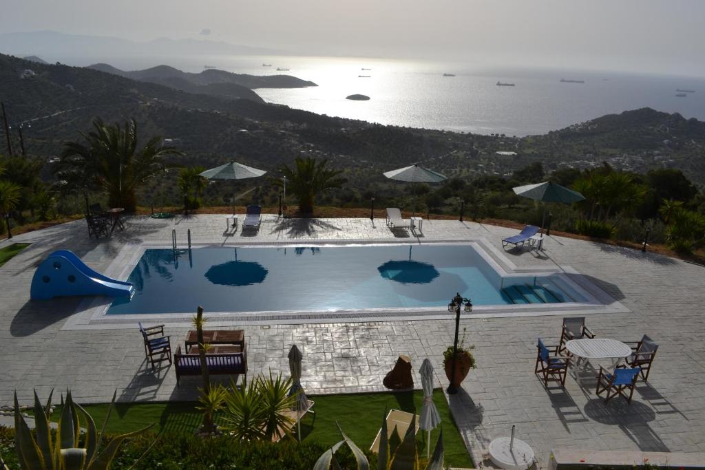 a swimming pool with a view of the ocean at Prosili in Aiándion