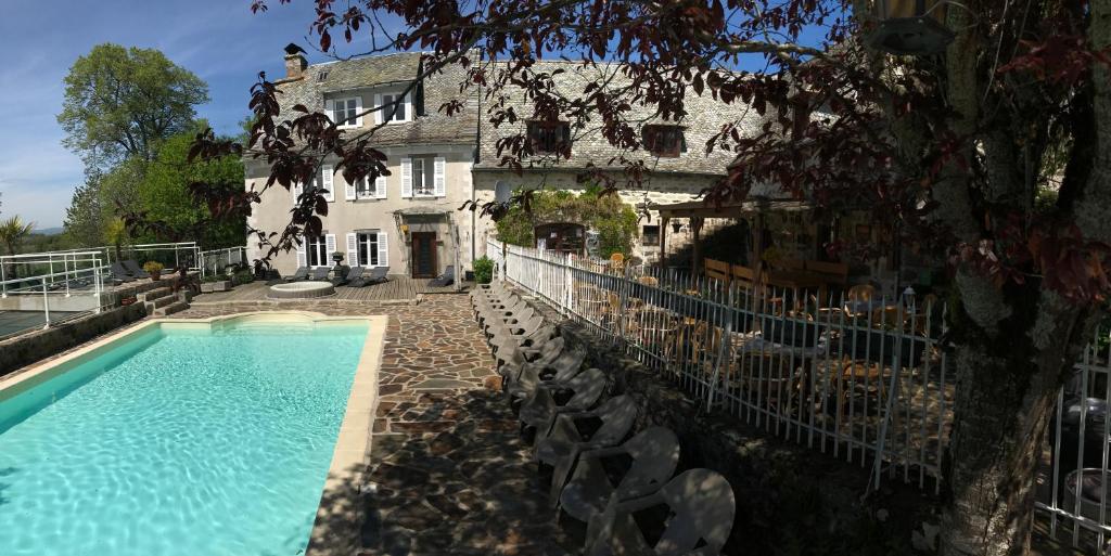 a house with a swimming pool in front of a building at Le clos de Banes in Banes