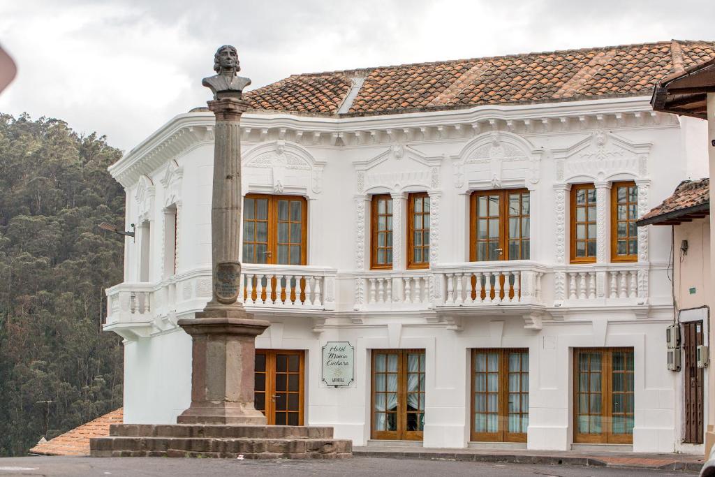 a white building with a pole in front of it at Mama Cuchara by Art Hotels in Quito