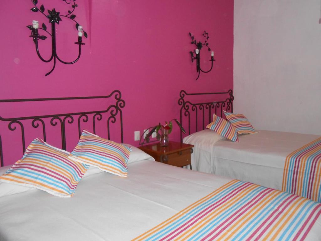 Postel nebo postele na pokoji v ubytování Hotel Posada Santo Niño