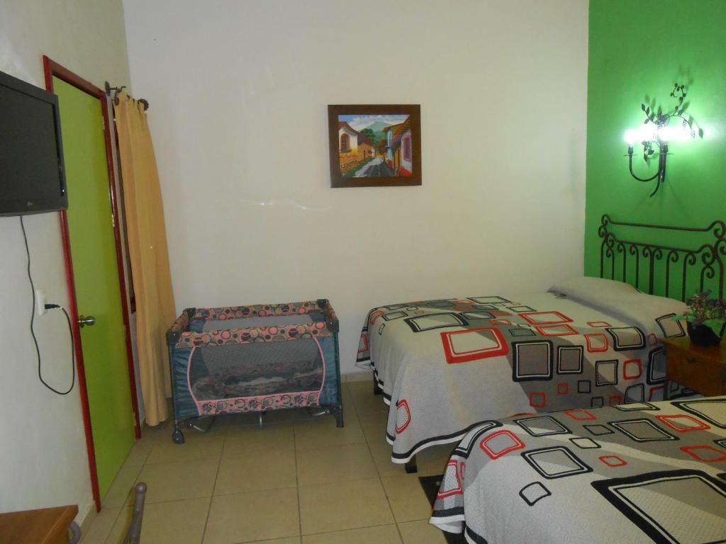 Postel nebo postele na pokoji v ubytování Hotel Posada Santo Niño
