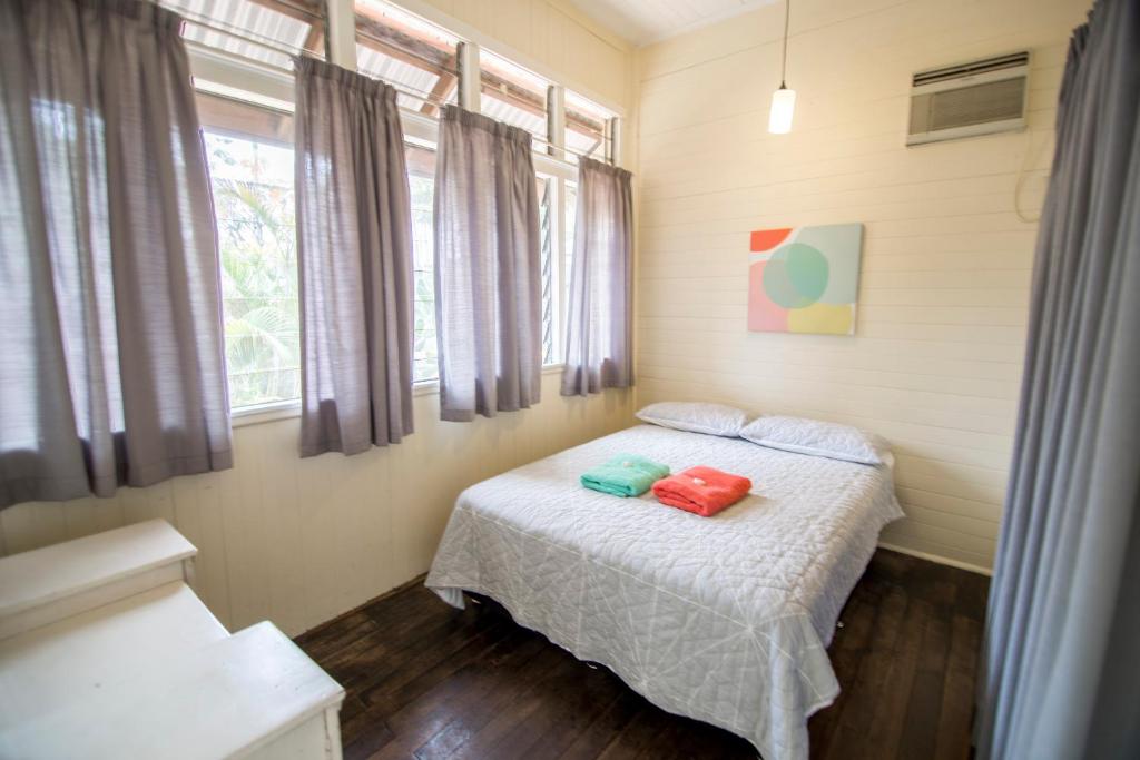 a bedroom with a bed with two pillows on it at Ryan's Rest Boutique Accommodation in Cairns
