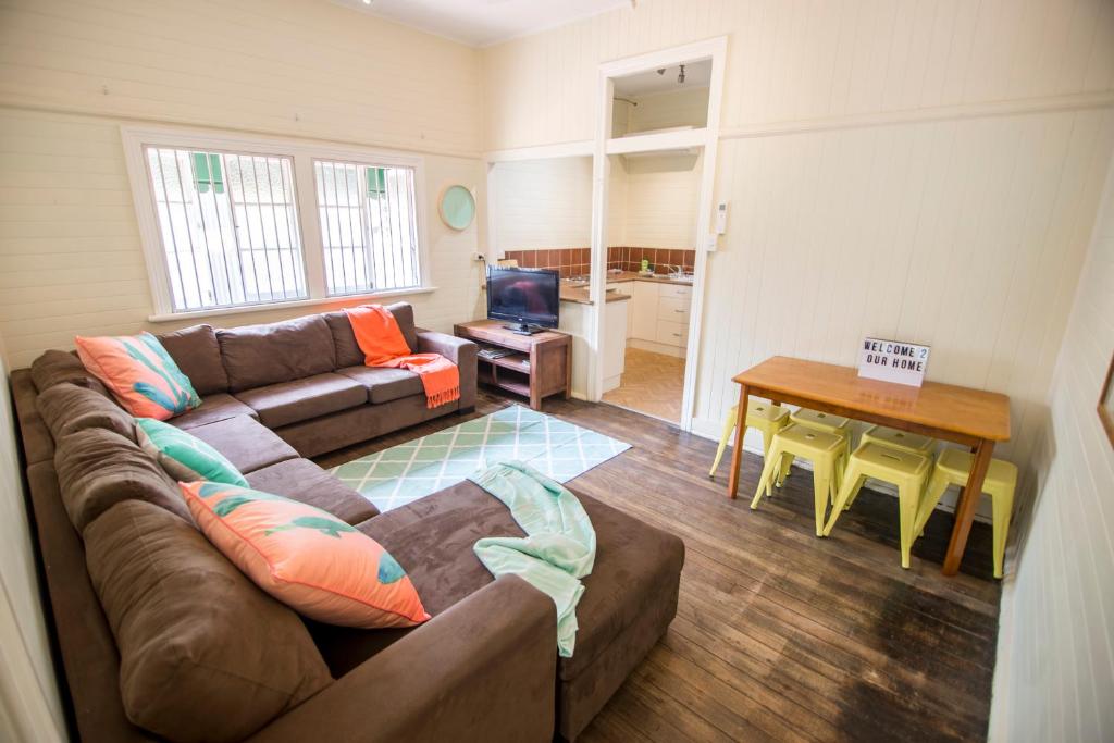 a living room with a couch and a table at Ryan's Rest Boutique Accommodation in Cairns