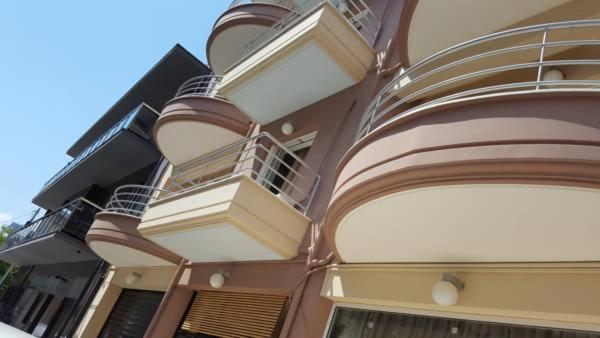 a building with balconies on the side of it at ALEXANDER Rooms in Nafplio