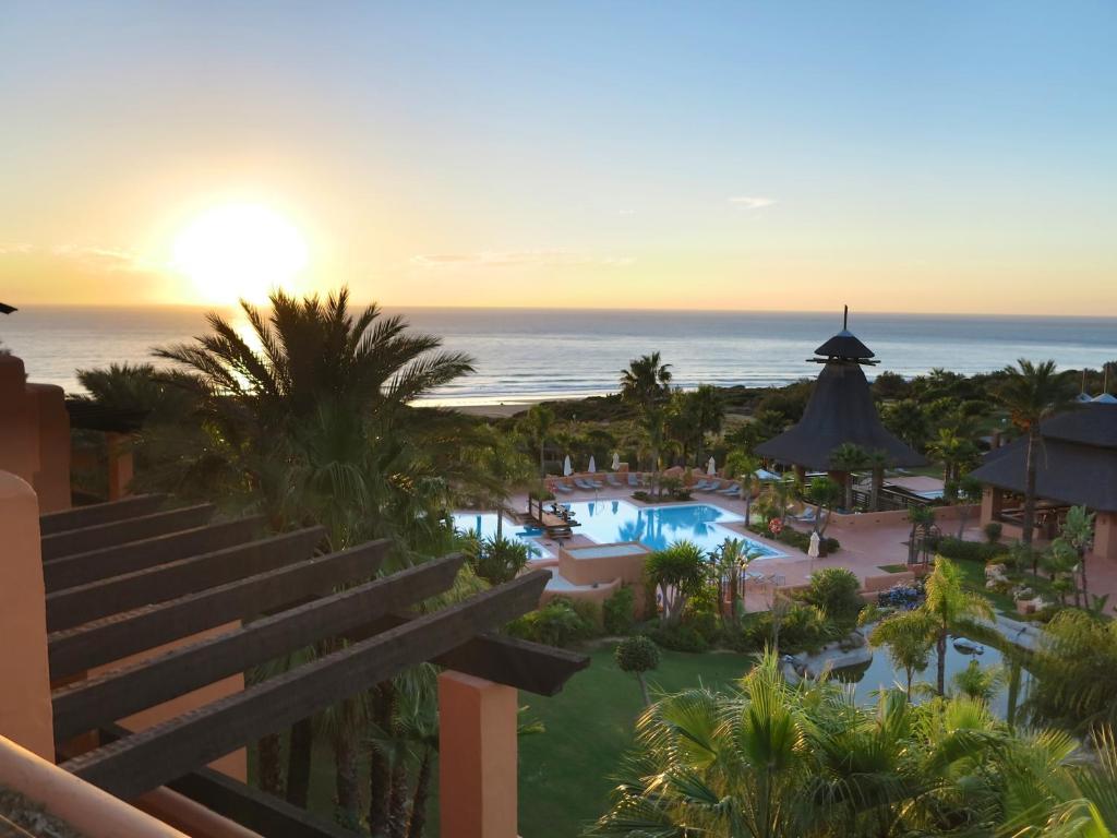 - Vistas a la piscina del complejo al atardecer en Aparthotel Novo Resort en Novo Sancti Petri