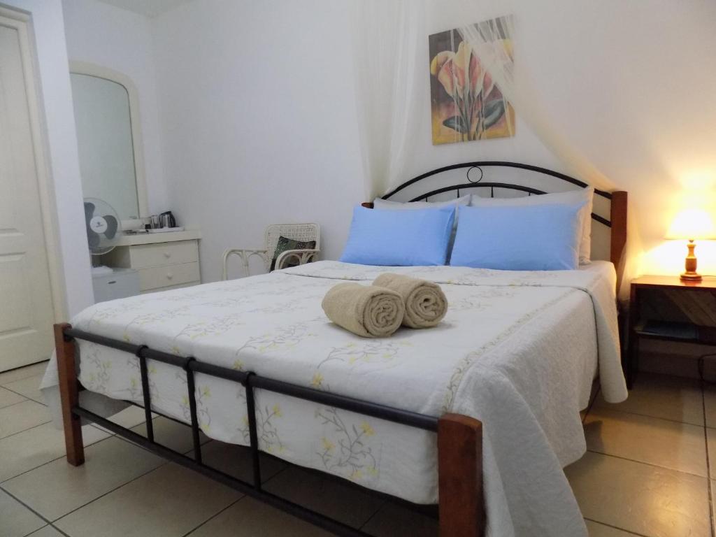 Postel nebo postele na pokoji v ubytování Villa Osumare Guest House