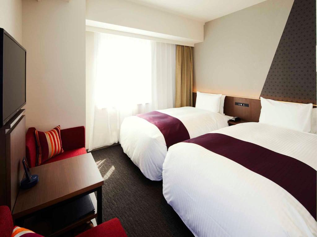 Postel nebo postele na pokoji v ubytování Hotel Intergate Tokyo Kyobashi