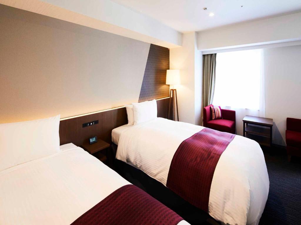 Postel nebo postele na pokoji v ubytování Hotel Intergate Tokyo Kyobashi