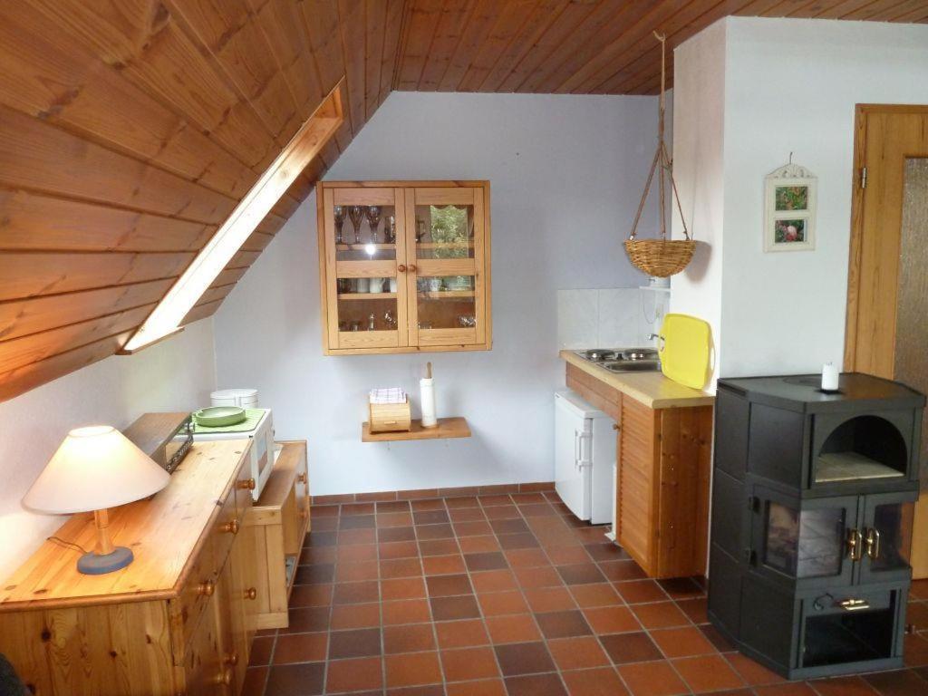 a kitchen with a stove top oven in a room at Ferienwohnung Bedey in Kiel