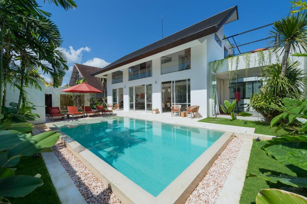 an image of a swimming pool in front of a house at Villa Alina in Seminyak