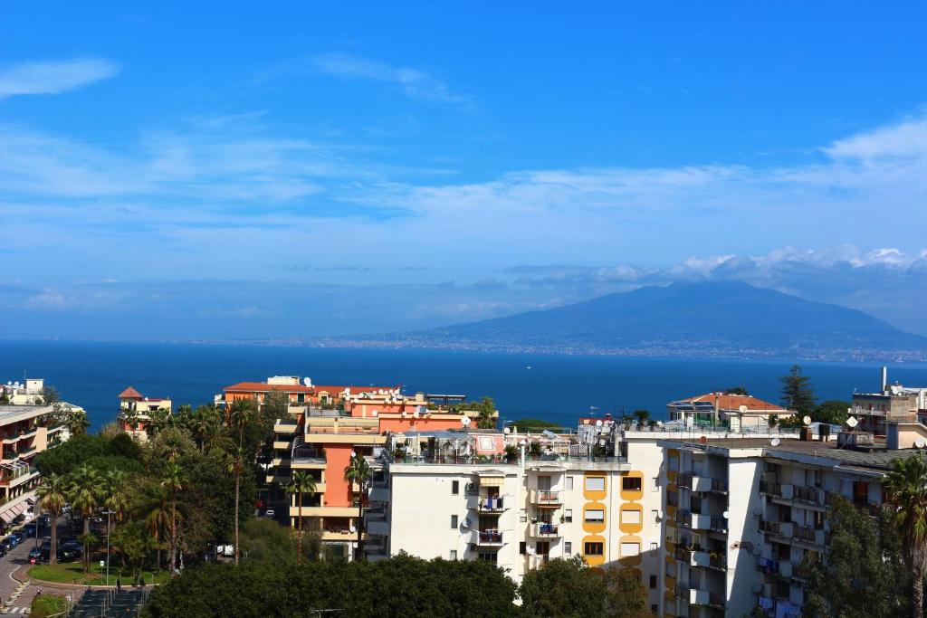a city with buildings and the ocean in the background at Casa Emilia in Sorrento