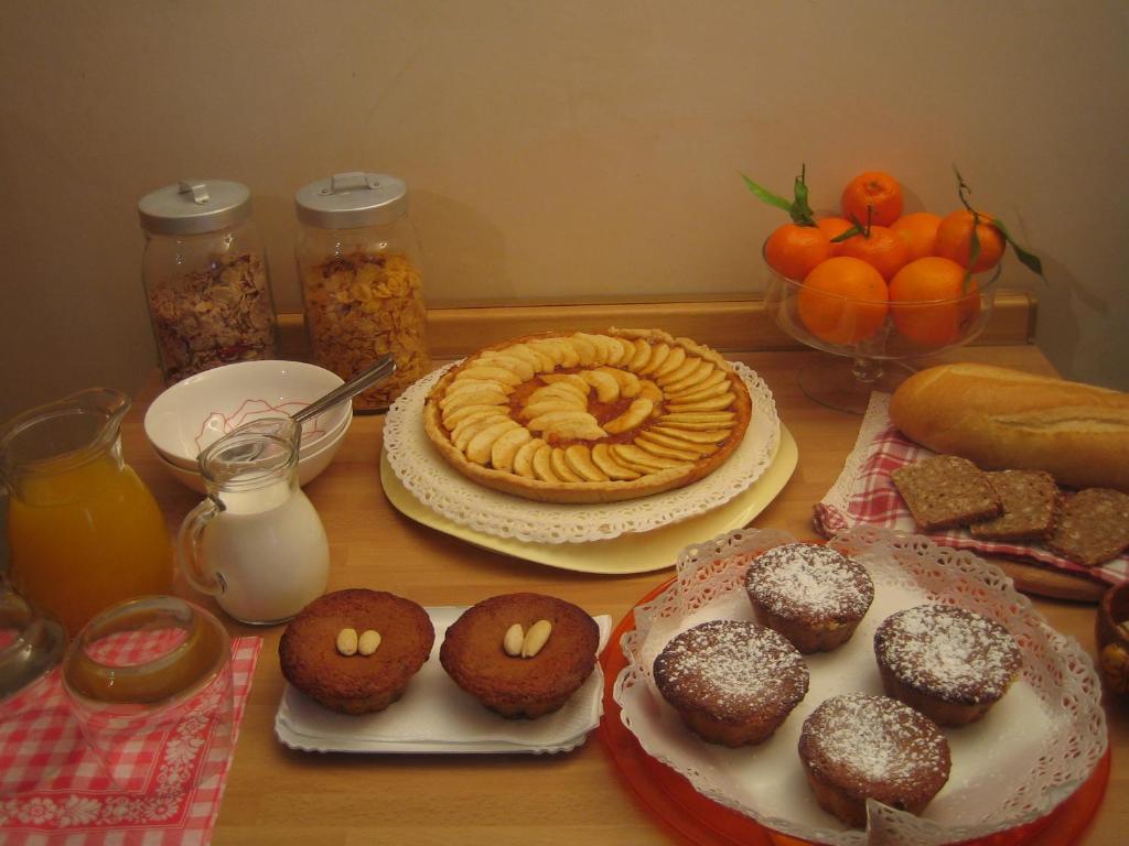 a wooden table topped with donuts and other foods at B&B Al Calicanto in Sorisole