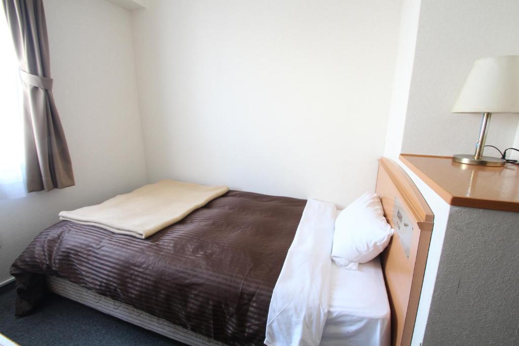 Postel nebo postele na pokoji v ubytování Sakura Hotel Hatagaya