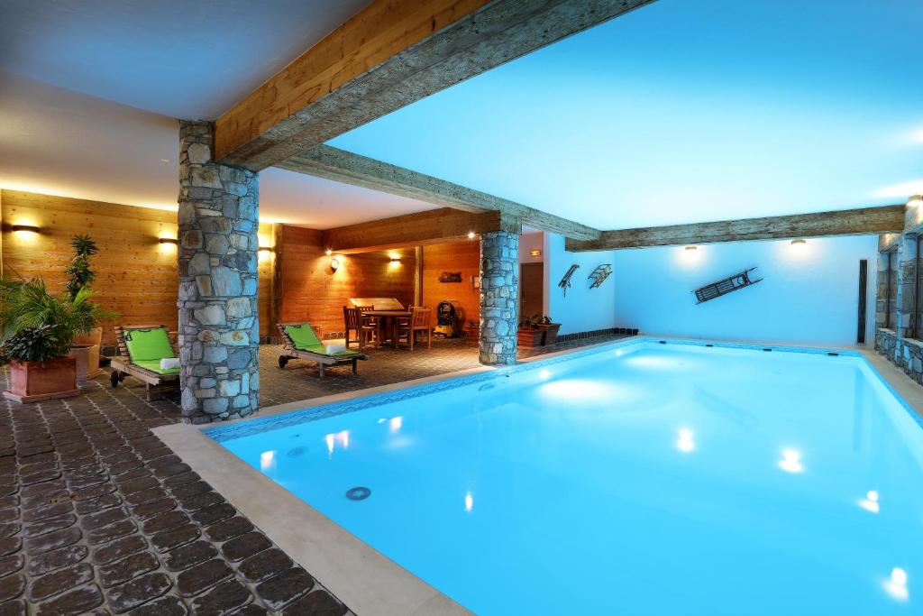 a swimming pool in the middle of a house at Hotel Autantic in Bourg-Saint-Maurice