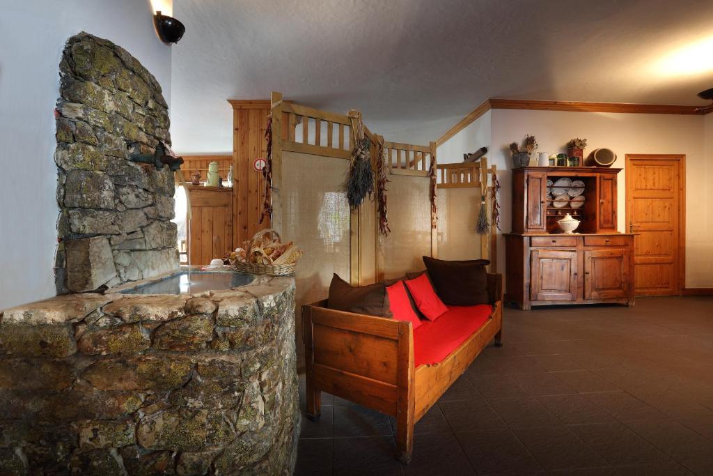 a living room with a stone fireplace and a couch at Hotel Autantic in Bourg-Saint-Maurice