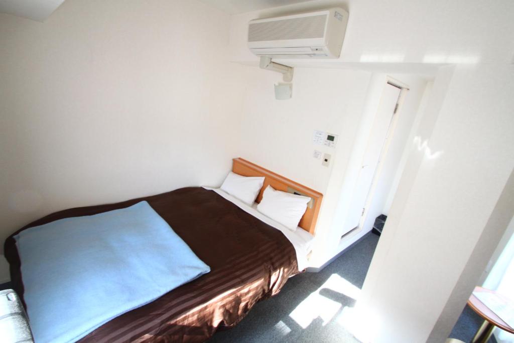 Postel nebo postele na pokoji v ubytování Sakura Hotel Hatagaya