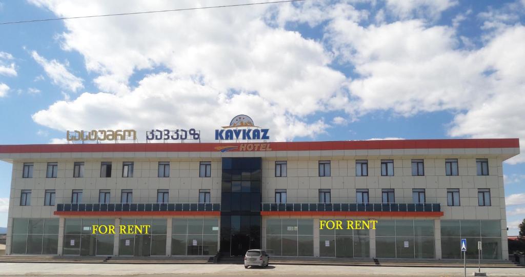 a white building with a for rent sign on top at KavKaz Hotel & Restaurant in Marneuli