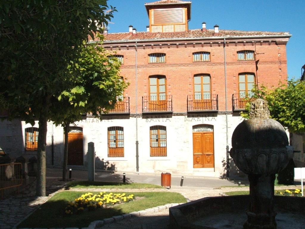 a large stone building with a statue of an elephant in front of it at Aparthotel Santa Marina in Cuéllar