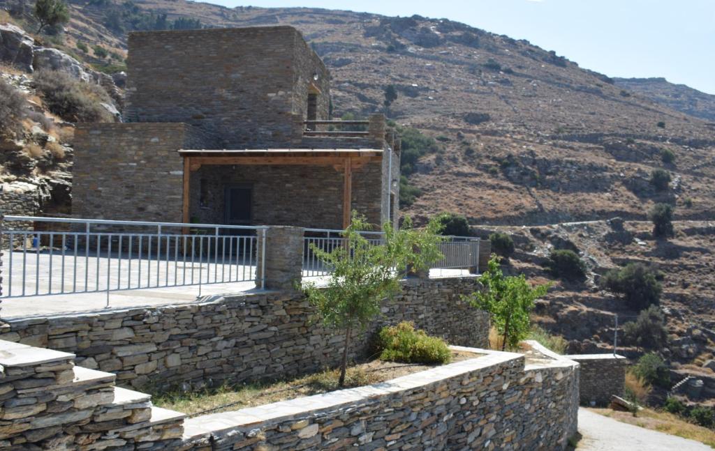 an old stone building with a stone wall at Sea View Stone Residence in Episkopión