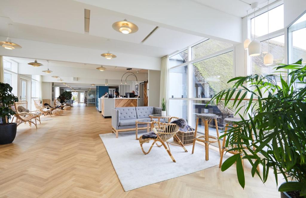 an office with chairs and tables and windows at Gl. Avernæs Sinatur Hotel & Konference in Ebberup