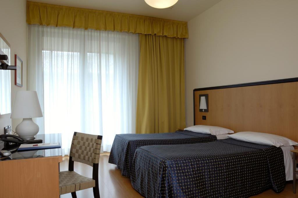 Posteľ alebo postele v izbe v ubytovaní Hotel Masini