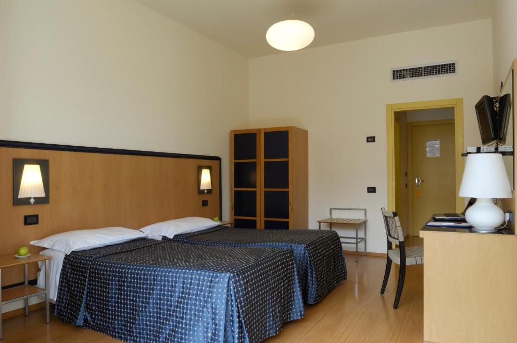 Posteľ alebo postele v izbe v ubytovaní Hotel Masini