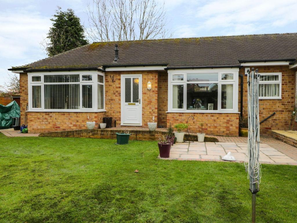 a brick house with a lawn in front of it at 14 Easby Lane in Great Ayton