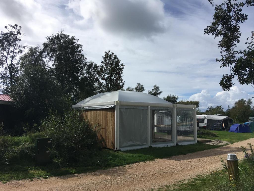 a tent on the side of a dirt road at Safaritent glamping tent nabij Sint Maartenszee in Sint Maartensvlotbrug