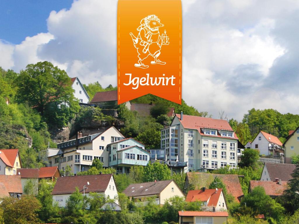 a sign in a town with houses and buildings at Berggasthof Hotel Igelwirt in Schnaittach